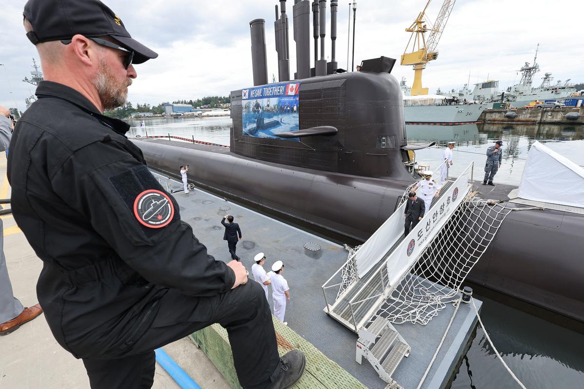 A Canadian submariner watches, as dignitaries and officers from the Canadian and South Korean Navies leave the South Korean KSS-III submarine ROKS Dosan Ahn Chang-ho, after they participated in a tour, at the home port of Canada's Pacific fleet, Canadian Forces Base (CFB) Esquimalt near Victoria, British Columbia, Canada, May 25, 2026. REUTERS/Chris Helgren