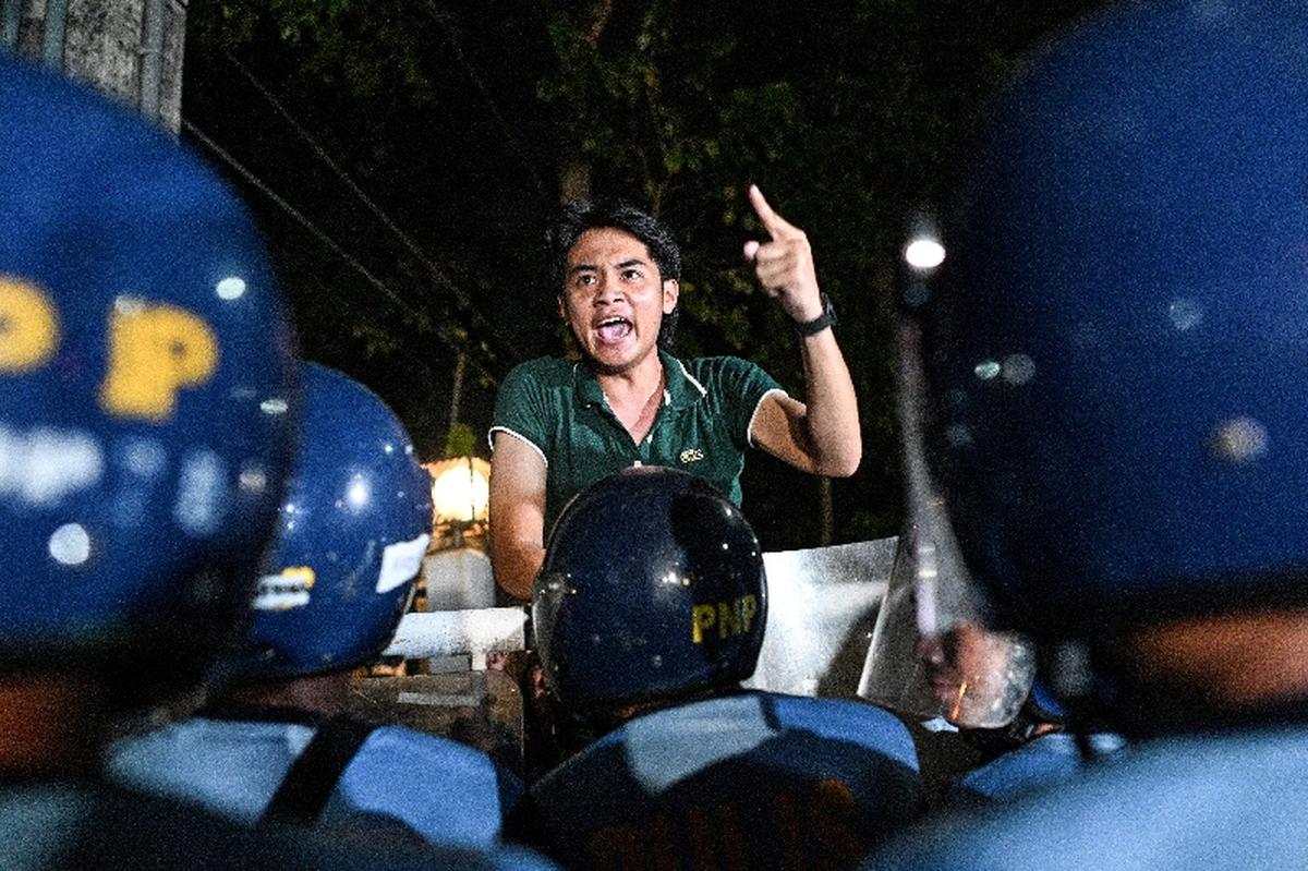 FILE PHOTO: A supporter of Philippine Senator Ronald "Bato" dela Rosa, ​the chief enforcer of former President Rodrigo Duterte's deadly "war on drugs," shouts towards police officers outside the Senate, which holds dela Rosa under protective custody amid an International Criminal Court warrant, in Pasay City, Metro Manila, Philippines, May 13, 2026. REUTERS/Noel Celis/File Photo