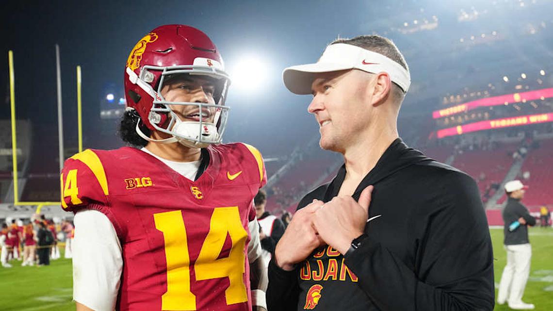  Nov 29, 2025; Los Angeles, California, USA; Southern California Trojans quarterback Jayden Maiava (14) and head coach Lincoln Riley react after the game against the UCLA Bruins at United Airlines Field at Los Angeles Memorial Coliseum. Mandatory Credit: Kirby Lee-Imagn Images | Kirby Lee-Imagn Images 