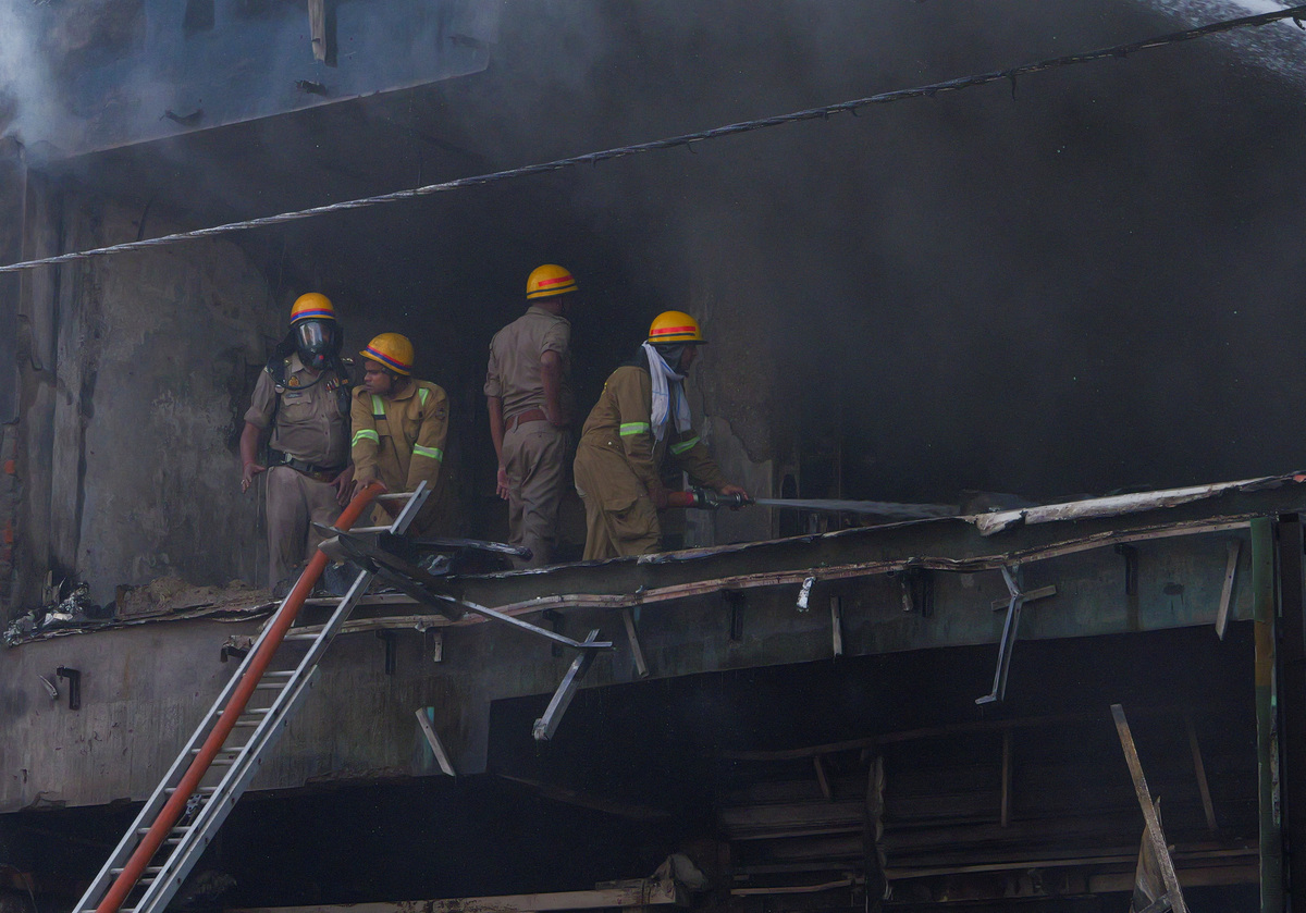 Firefighters douse a deadly fire at a coaching centre in Lucknow, India, June 22, 2026. REUTERS/STRINGER