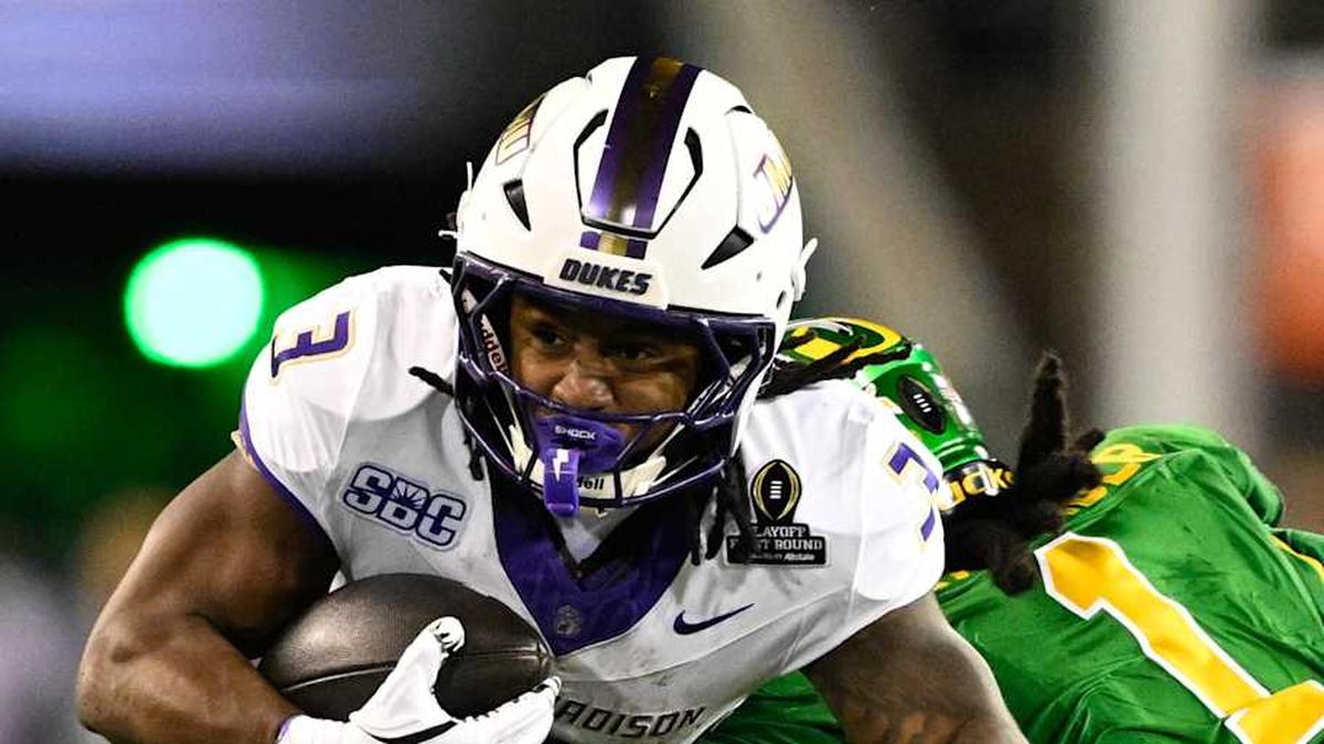  Dec 20, 2025; Eugene, OR, USA; James Madison Dukes running back Wayne Knight (3) rushes as Oregon Ducks defensive back Aaron Flowers (21) defends during the second quarter at Autzen Stadium. Mandatory Credit: Troy Wayrynen-Imagn Images | Troy Wayrynen-Imagn Images 