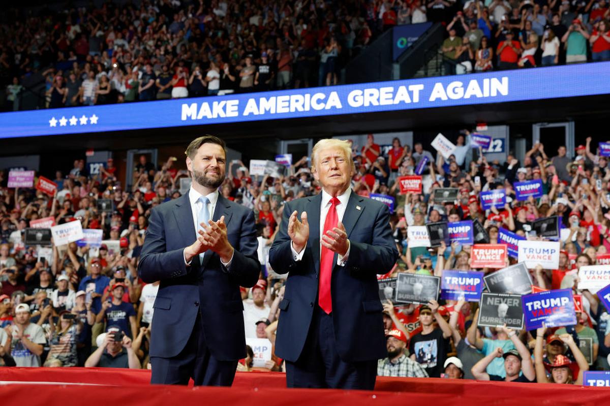 Former President Donald Trump stands onstage with Republican vice presidential candidate Sen. J.D. Vance during a July rally in Grand Rapids, Michigan. (Photo by Anna Moneymaker/Getty Images)