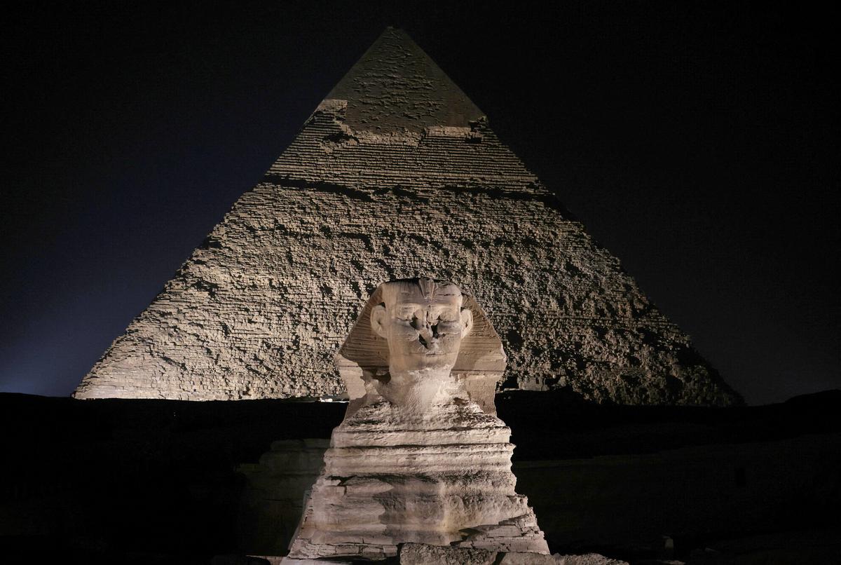 FILE PHOTO: The Giza Pyramids and the Sphinx are lit up during the celebration of World Tourism Day at Giza, on the outskirts of Cairo, Egypt, September 27, 2024. REUTERS/Mohamed Abd El Ghany/File Photo