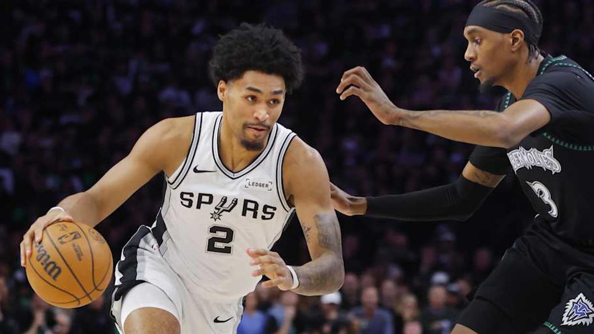  May 10, 2026; Minneapolis, Minnesota, USA; San Antonio Spurs guard Dylan Harper (2) works around Minnesota Timberwolves forward Jaden McDaniels (3) in the first quarter of game four of the second round of the 2026 NBA Playoffs at Target Center. | Bruce Kluckhohn-Imagn Images 