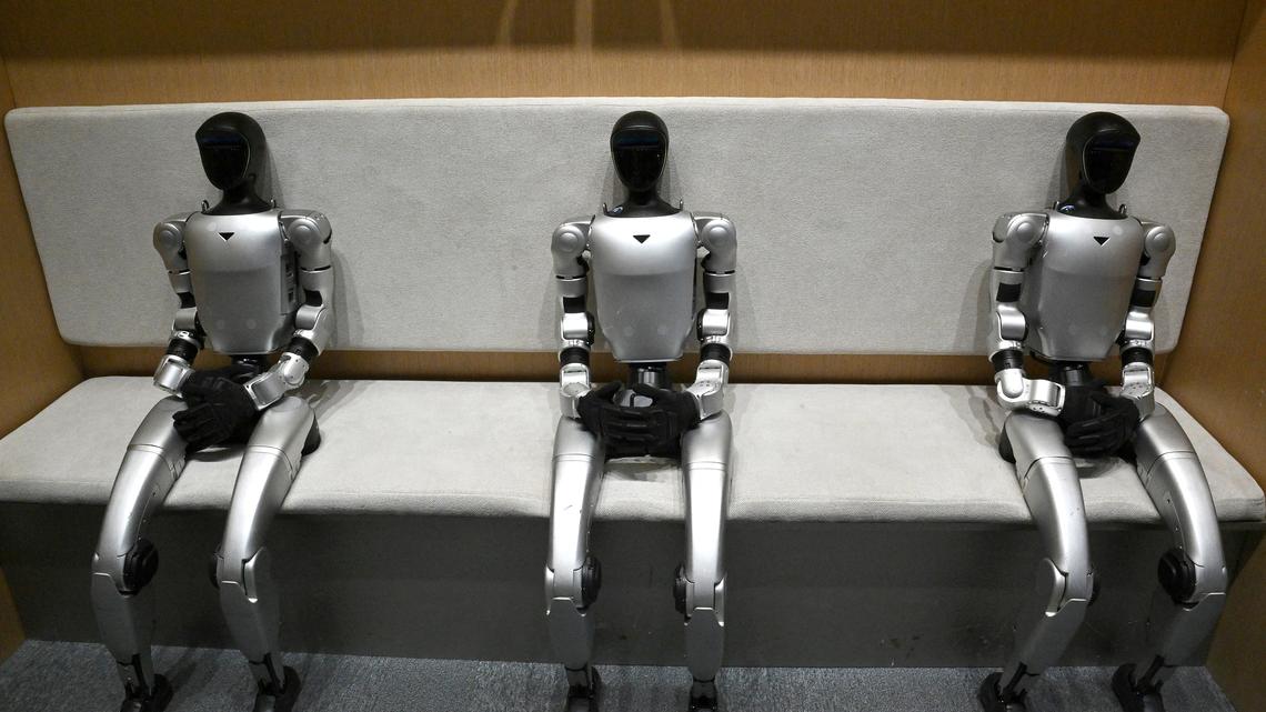 Three Unitree G1 humanoid robots are pictured at robotics company Unitree's first retail store in Beijing in Jan. 9, 2026. (Adek Berry/AFP/Getty Images/TNS)