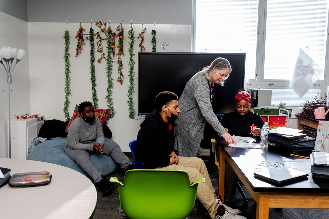  Jannine Blosser, a science support teacher, helps eighth graders Caleb Stevenson, Dominic Willis and Jasmine Wilcox work through an interactive activity about genetics at the McKinley STEAM Academy on March 12, 2026, in Toledo, Ohio. Credit: Sylvia Jarrus for The Hechinger Report