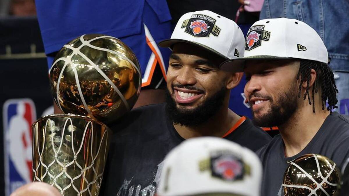  Jun 13, 2026; San Antonio, Texas, USA; New York Knicks center Karl-Anthony Towns (L) holds the Larry O'Brien championship trophy as Knicks guard Jalen Brunson (R) holds the Finals MVP trophy after game five of the 2026 NBA Finals against the San Antonio Spurs at Frost Bank Center. Mandatory Credit: Geoff Burke-Imagn Images | Geoff Burke-Imagn Images 