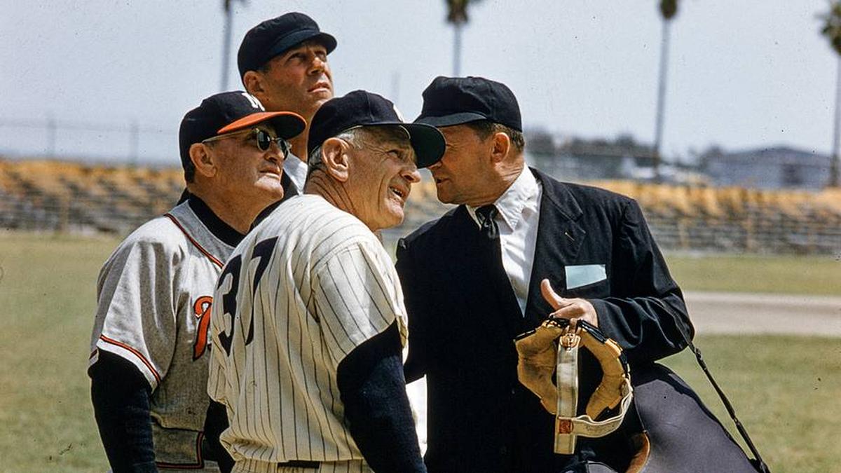  Yankees manager Casey Stengel (foreground) speaks with Braves manager Fred Haney speak and umpires during a 1957 spring training game. | John G. Zimmerman/Sports Illustrated 