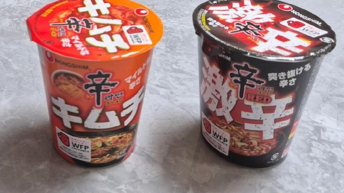 Shin Ramyun cup noodles sold in South Korea (left) alongside Kimchi Shin Ramyun and Shin Ramyun Red cups sold in Japan. Photo by Asia Today
                                            