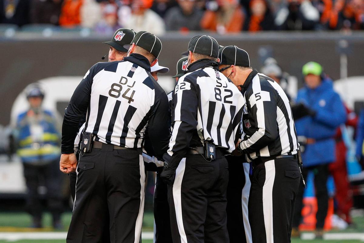  NFL refs on field. 