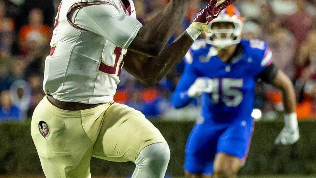  Nov 29, 2025; Gainesville, Florida, USA; Florida State Seminoles running back Ousmane Kromah (32) attempts to catch the ball during the second quarter against the Florida Gators at Ben Hill Griffin Stadium. Mandatory Credit: Bob Kupbens-Imagn Images | Bob Kupbens-Imagn Images 