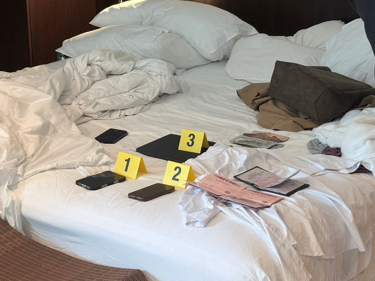 Evidence related to a Russian man, Denis Obrezko, lies on a bed in Phuket, Thailand, November 12, 2025. U.S. prosecutors say Denis Obrezko previously worked for Russia's FSB intelligence agency.   Thailand's Cyber Crime Investigation Bureau/Handout via REUTERS