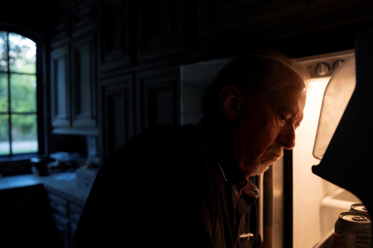 Menta "Steve" Wallace puts back a bag with bottles of daraxonrasib back into his refrigerator at his home in The Woodlands, Texas, U.S., May 29, 2026. Wallace is taking daraxonrasib in a clinical trial, which is Revolution Medicine's pancreatic cancer drug.   REUTERS/Danielle Villasana