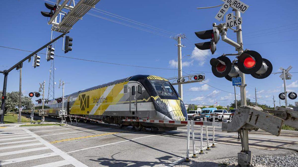 A Brightline train makes its way past the intersection of Northeast 48th Street and North Dixie Highway on Wednesday, Oct. 22, 2025, in Pompano Beach, Fla. (Matias J. Ocner/Miami Herald/TNS)