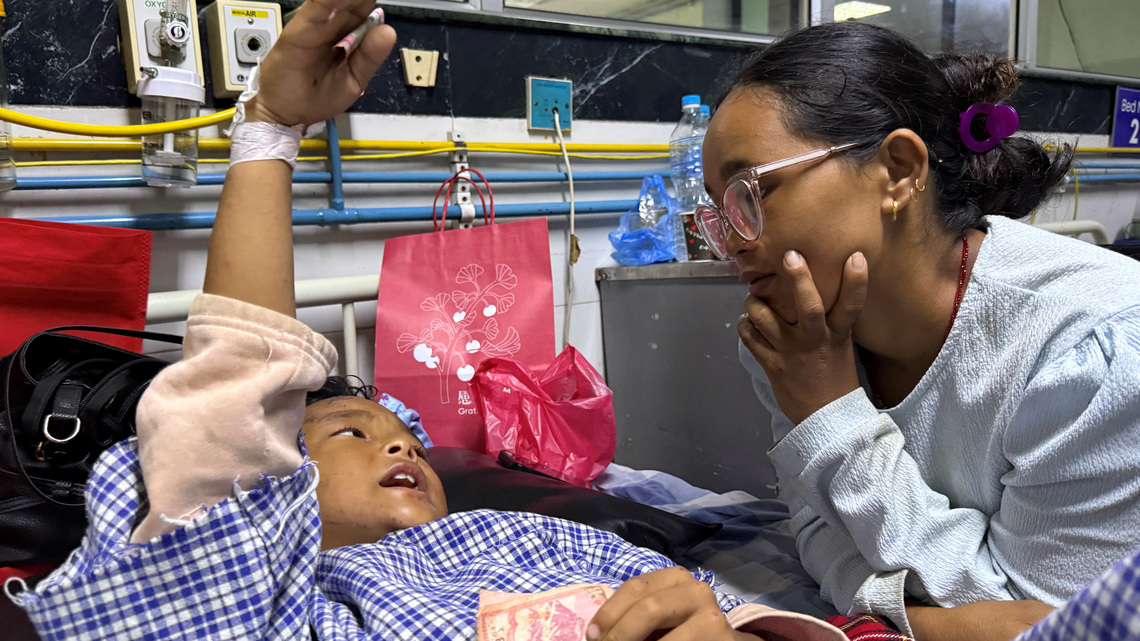 Mother reunited with 8-year-old who climbed trees to survive Nepal floods