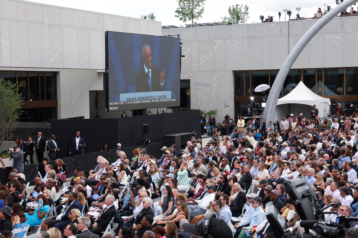 Attendees listen as former U.S. President Barack Obama speaks, as seen from a screen, during the dedication ceremony for the opening of the Obama Presidential Center in Chicago, Illinois, U.S., June 18, 2026. REUTERS/Brendan McDermid