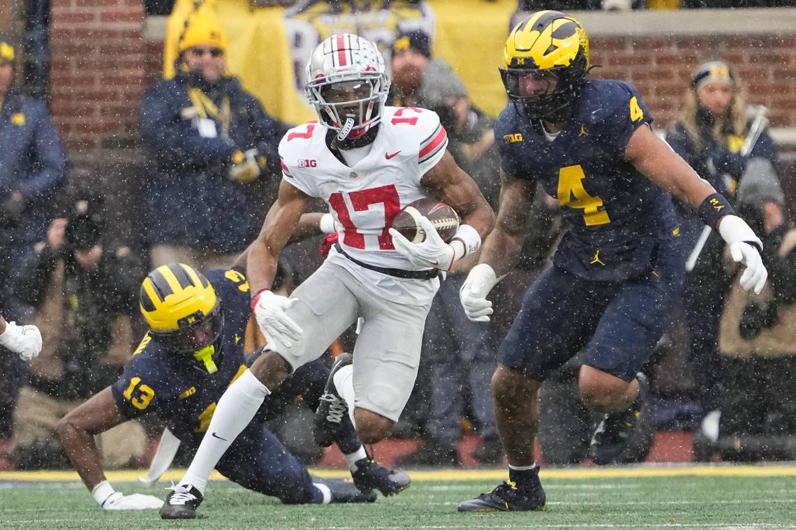  Ohio State Buckeyes wide receiver Carnell Tate eludes Michigan Wolverines defenders in Ann Arbor, Michigan, on Nov. 29, 2025. Adam Cairns / Columbus Dispatch / USA TODAY NETWORK via Imagn Images