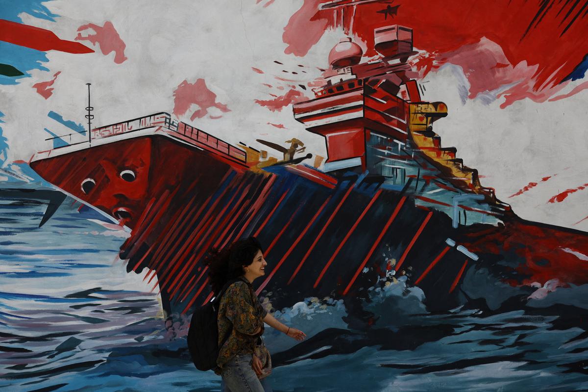 An Iranian woman walks next to a mural on a street in Tehran, Iran, May 6, 2026. Majid Asgaripour/WANA (West Asia News Agency) via REUTERS