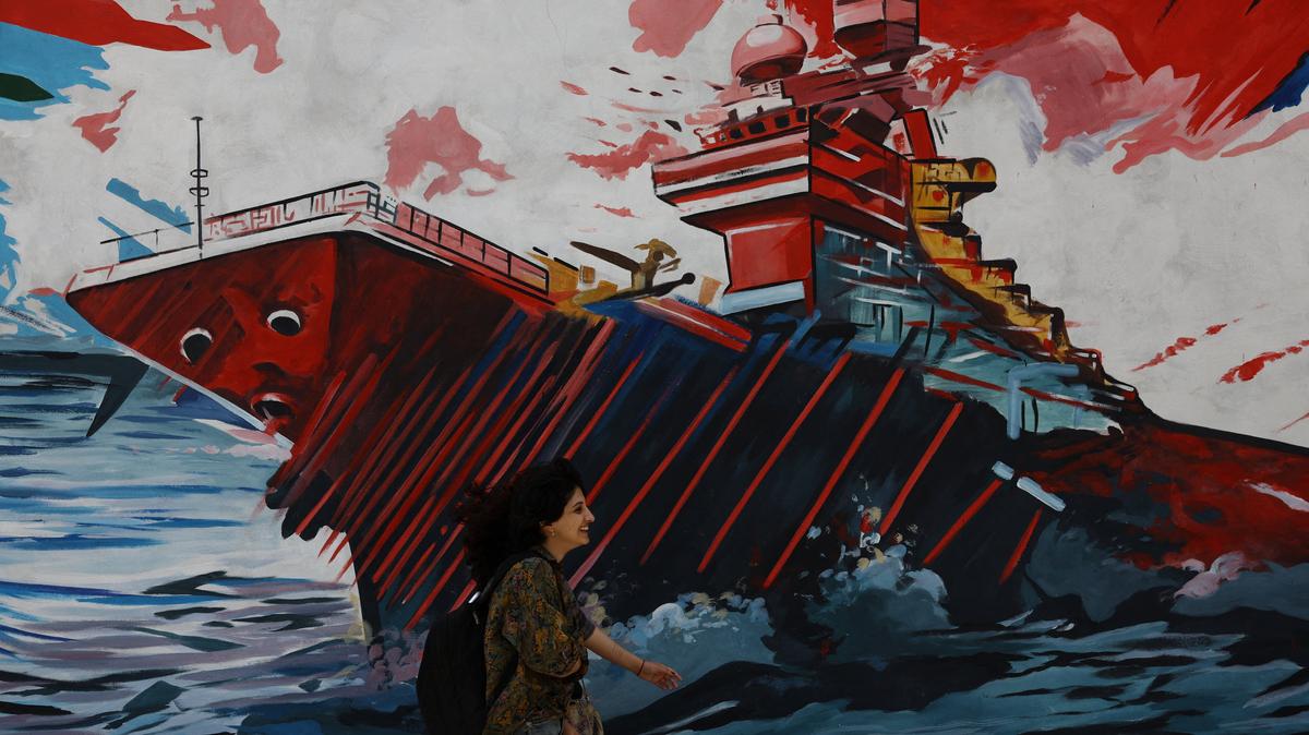 An Iranian woman walks next to a mural on a street in Tehran, Iran, May 6, 2026. Majid Asgaripour/WANA (West Asia News Agency) via REUTERS
