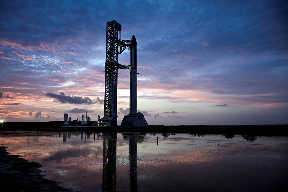 The SpaceX Starship and Super Heavy v3 Booster stand at pad 2 at sunrise before its 13th test flight from the SpaceX launch complex in Starbase, Texas, U.S., July 16, 2026. REUTERS/Steve Nesius