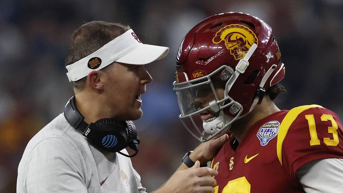  Jan 2, 2023; Arlington, Texas, USA; USC Trojans head coach Lincoln Riley talks to quarterback Caleb Williams (13) during the game against the Tulane Green Wave in the 2023 Cotton Bowl at AT&T Stadium. Mandatory Credit: Tim Heitman-Imagn Images | Tim Heitman-Imagn Images 