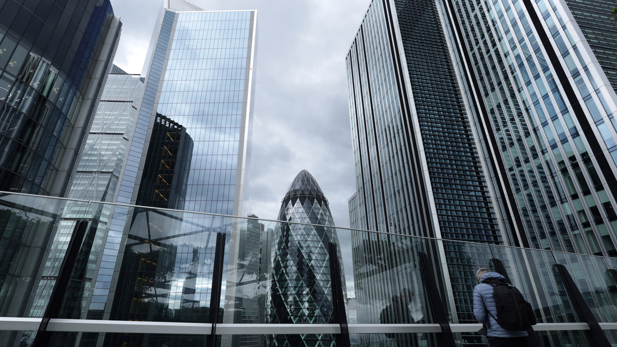 FILE PHOTO: A visitor looks out from the viewing area of Garden at 120 with commercial skyscrapers including The Gherkin seen behind, in the City of London financial district, in London, Britain, September 23, 2025. REUTERS/Toby Melville/File Photo