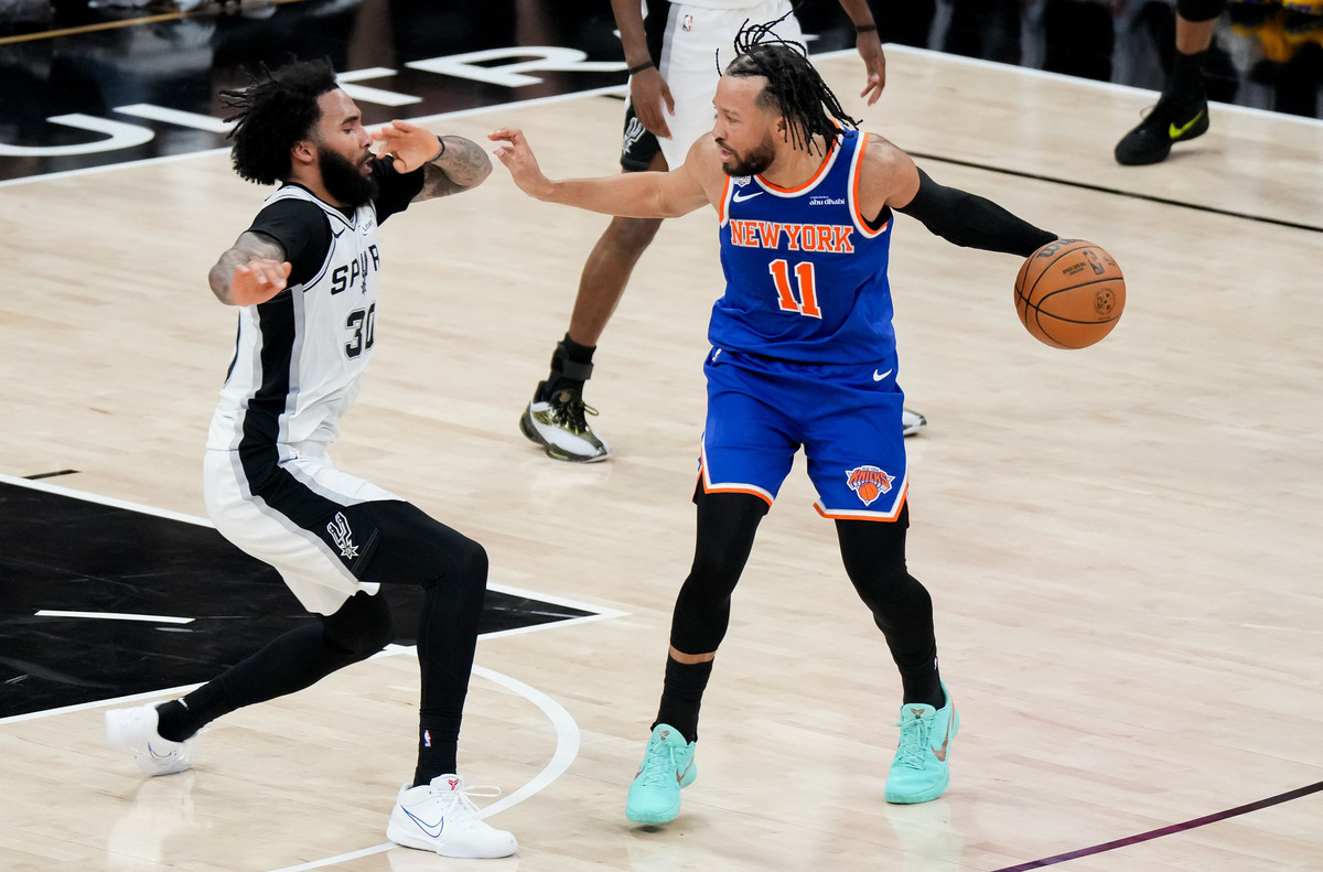 Jun 13, 2026; San Antonio, Texas, USA; New York Knicks guard Jalen Brunson (11) dribbles the ball against San Antonio Spurs forward Julian Champagnie (30) in the second half during game five of the 2026 NBA Finals at Frost Bank Center. Mandatory Credit: Scott Wachter-Imagn Images