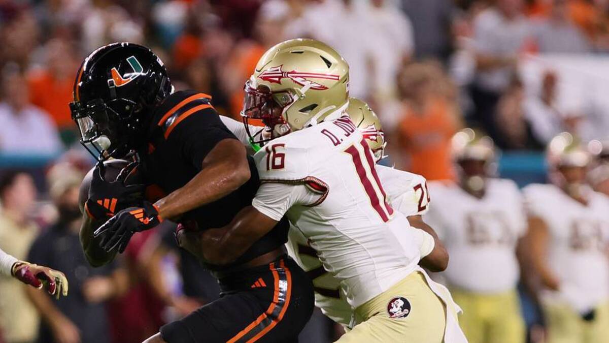  Oct 26, 2024; Miami Gardens, Florida, USA; Miami Hurricanes wide receiver Isaiah Horton (2) runs with the football ahead of Florida State Seminoles defensive back Quindarrius Jones (16) during the second quarter at Hard Rock Stadium. Mandatory Credit: Sam Navarro-Imagn Images | USA TODAY Sports via Reuters Connect 