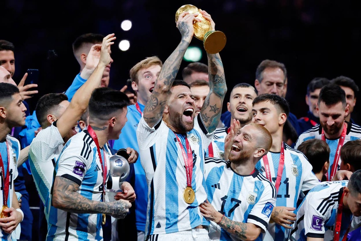  Nicolas Otamendi of Aregntina holds up the World Cup trophy as he and his teammates celebrate after winning the 2022 final against France. Yukihito Taguchi-USA TODAY Sports