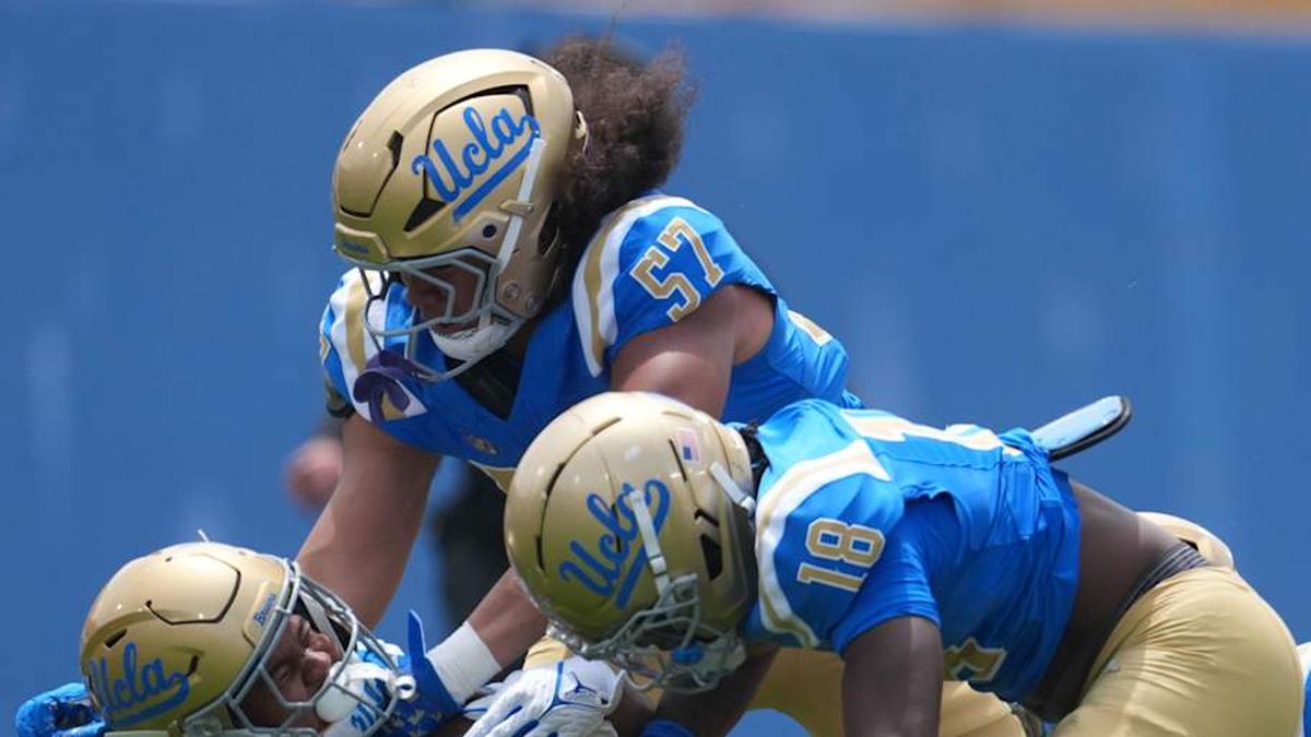  May 2, 2026; Pasadena, CA, USA; UCLA Bruins linebacker Matthew Muasau (57) and defensive backs Osiris Gilbert (18) and Cole Martin (4) tackle receiver Jonah Smith (24) during the spring game at Rose Bowl. Mandatory Credit: Kirby Lee-Imagn Images | Kirby Lee-Imagn Images 