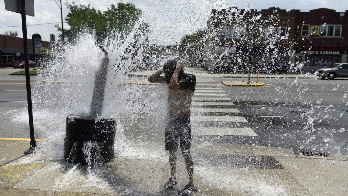 A person cools off with water from an open fire hydrant during a heat wave on the West Side of Chicago, Illinois, on July 2, 2026. Blistering temperatures and humidity gripped swaths of the United States on July 1, with the worst yet to come for the densely populated East Coast as the nation co-hosts the World Cup and prepares to celebrate its 250th birthday. "Heat dome" conditions — in which high-pressure systems trap warm air like the lid on a pot — persisted over the Midwest and South and were moving east, with some 46 million people under heat alerts. (Octavio Jones/AFP via Getty Images/TNS)