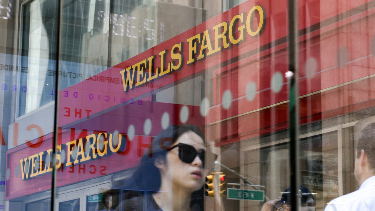 A Wells Fargo bank logo is pictured through glass in New York City, U.S., June 4, 2025. REUTERS/Kylie Cooper