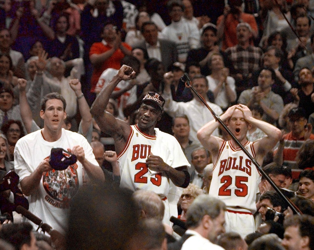  Jun 13, 1997; Chicago, IL, USA; Chicago Bulls players Judd Buechler, left, Michael Jordan, middle, and Steve Kerr celebrate after winning the NBA championship after defeating the Utah Jazz in the 1997 NBA Finals at the United Center. 