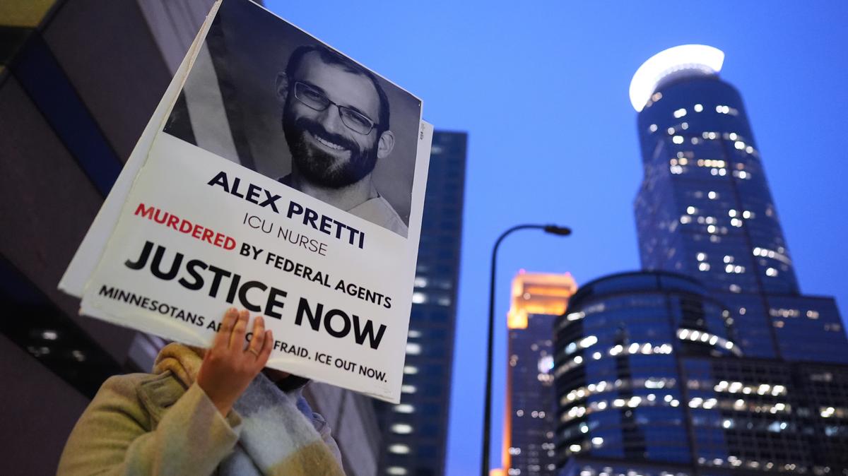 A person holds a sign of Alex Pretti during a protest outside the office of Sen. Amy Klobuchar, D-Minn., on Monday, Jan. 26, 2026, in Minneapolis. (AP Photo/Adam Gray)