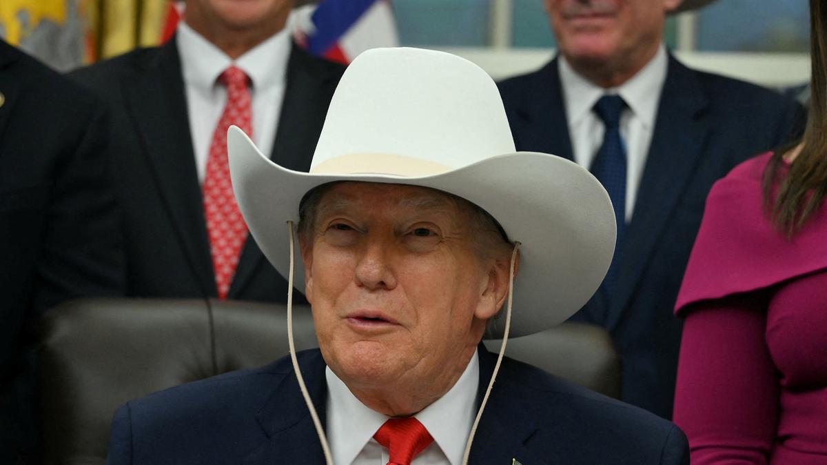 U.S. President Donald Trump wears a cowboy hat during a bill signing ceremony with members of the 1980 U.S. Olympic men's ice hockey team in the Oval Office of the White House in Washington, D.C., on Dec. 12, 2025. The legislation will award all of the players with Congressional Gold Medals to recognize the 45th anniversary of the U.S. victory at the 1980 Winter Olympic Games.