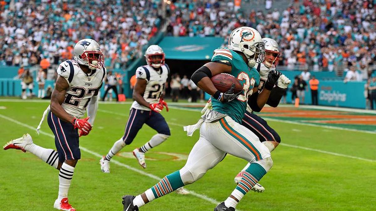  Dec 9, 2018; Miami Gardens, FL, USA; Miami Dolphins running back Kenyan Drake (32) runs the ball for a walk off touchdown against the New England Patriots during the second half at Hard Rock Stadium. Mandatory Credit: Jasen Vinlove-Imagn Images | Jasen Vinlove-Imagn Images 