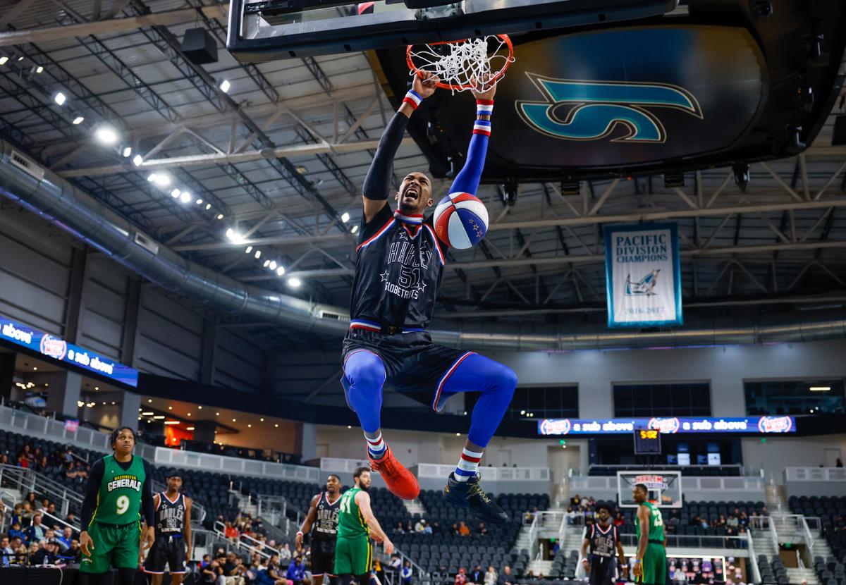 The Harlem Globetrotters’ Andrew “Big Dog” Whitsett (51) dunks the ball at Tech CU Arena in San Jose, Calif., on Saturday, Jan. 18, 2025.
