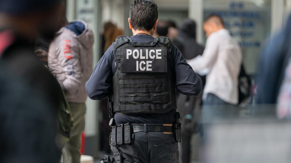 Green card holder detained in Washington. A US Immigration and Customs enforcement agent monitors asylum seekers in New York City on June 6, 2023.