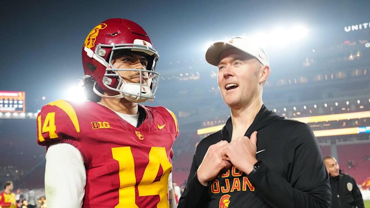  Nov 29, 2025; Los Angeles, California, USA; Southern California Trojans quarterback Jayden Maiava (14) and head coach Lincoln Riley react after the game against the UCLA Bruins at United Airlines Field at Los Angeles Memorial Coliseum. Mandatory Credit: Kirby Lee-Imagn Images | Kirby Lee-Imagn Images 