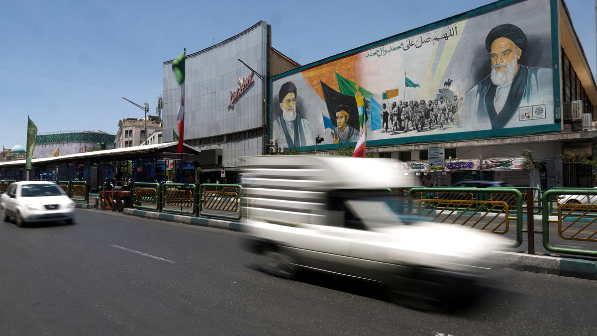 People drive past a mural depicting the late leader of the Islamic Revolution, Ayatollah Ruhollah Khomeini, and Iran's late Supreme Leader Ayatollah Ali Khamenei, on a street in Tehran, Iran, June 14, 2026. Majid Asgaripour/WANA (West Asia News Agency) via REUTERS