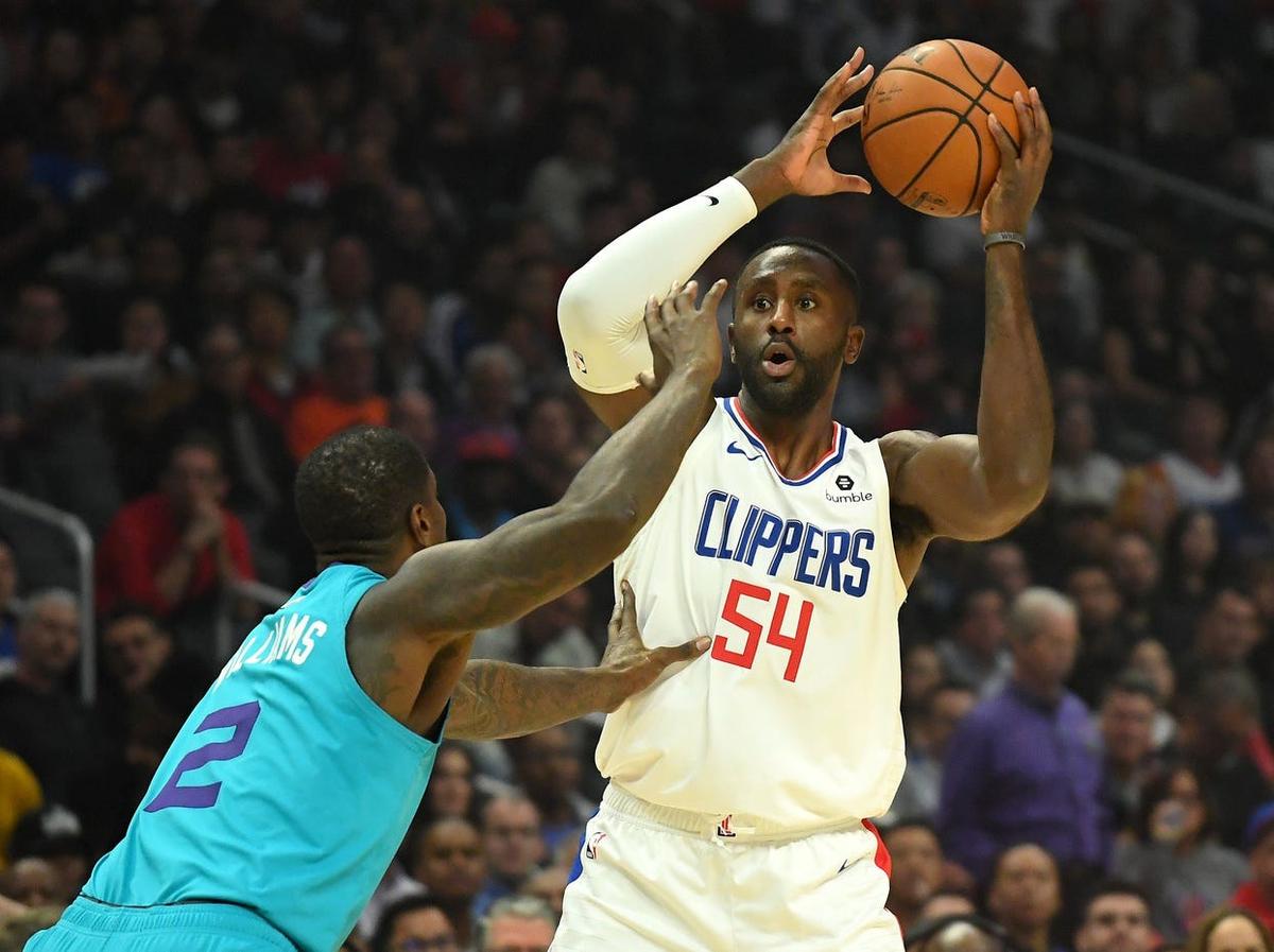 Oct 28, 2019; Los Angeles, CA, USA; LA Clippers forward Patrick Patterson (54) looks to pass the ball defended by Charlotte Hornets forward Marvin Williams (2) in the first quarter of the game at Staples Center. Mandatory Credit: Jayne Kamin-Oncea-USA TODAY Sports