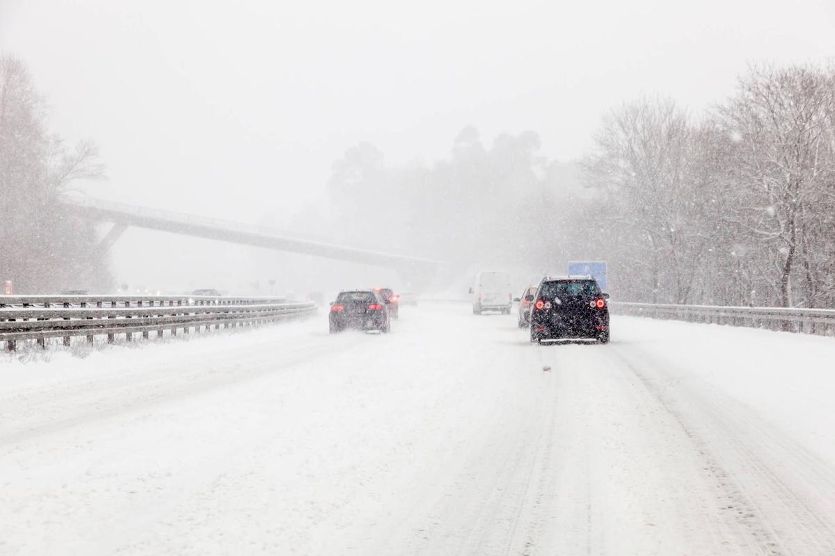  Cars driving on a highway covered with snow during a snowstorm Getty Images