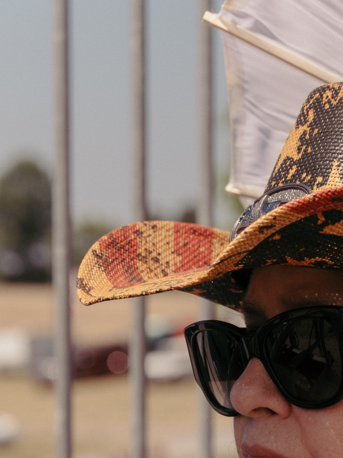 An attendee with a parasol at Daniel Lady Farm, a historic site in Gettysburg, Pa., during celebrations of the 250th anniversary of the United States, July 4, 2026. America celebrates the 250th anniversary of its independence today, with people from one end of the country to the other marking the milestone with fireworks, parades and concerts. (Caroline Gutman/The New York Times)