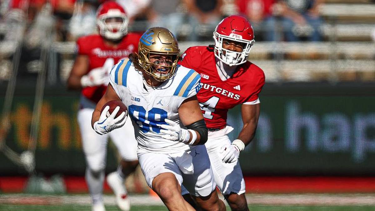  Oct 19, 2024; Piscataway, New Jersey, USA; UCLA Bruins tight end Moliki Matavao (88) gains yards after catch as Rutgers Scarlet Knights defensive back Desmond Igbinosun (4) during the second half at SHI Stadium. Mandatory Credit: Vincent Carchietta-Imagn Images | Vincent Carchietta-Imagn Images 