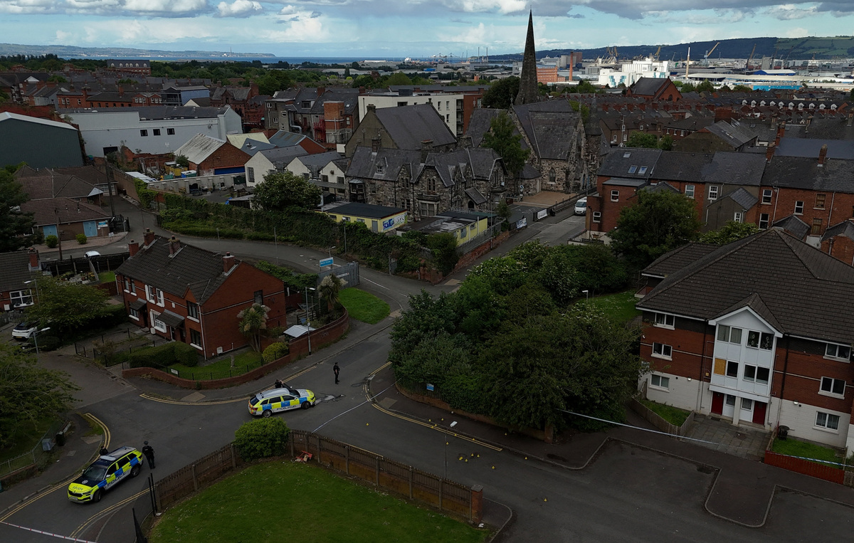 A drone view of police vehicles near a cordon at the scene of a stabbing outside apartments in the Kinnaird Avenue area of north Belfast, after a knife attack on June 8 left a man seriously injured and prompted police to declare a critical incident, in Belfast, Northern Ireland, June 9, 2026. REUTERS/Isabel Infantes