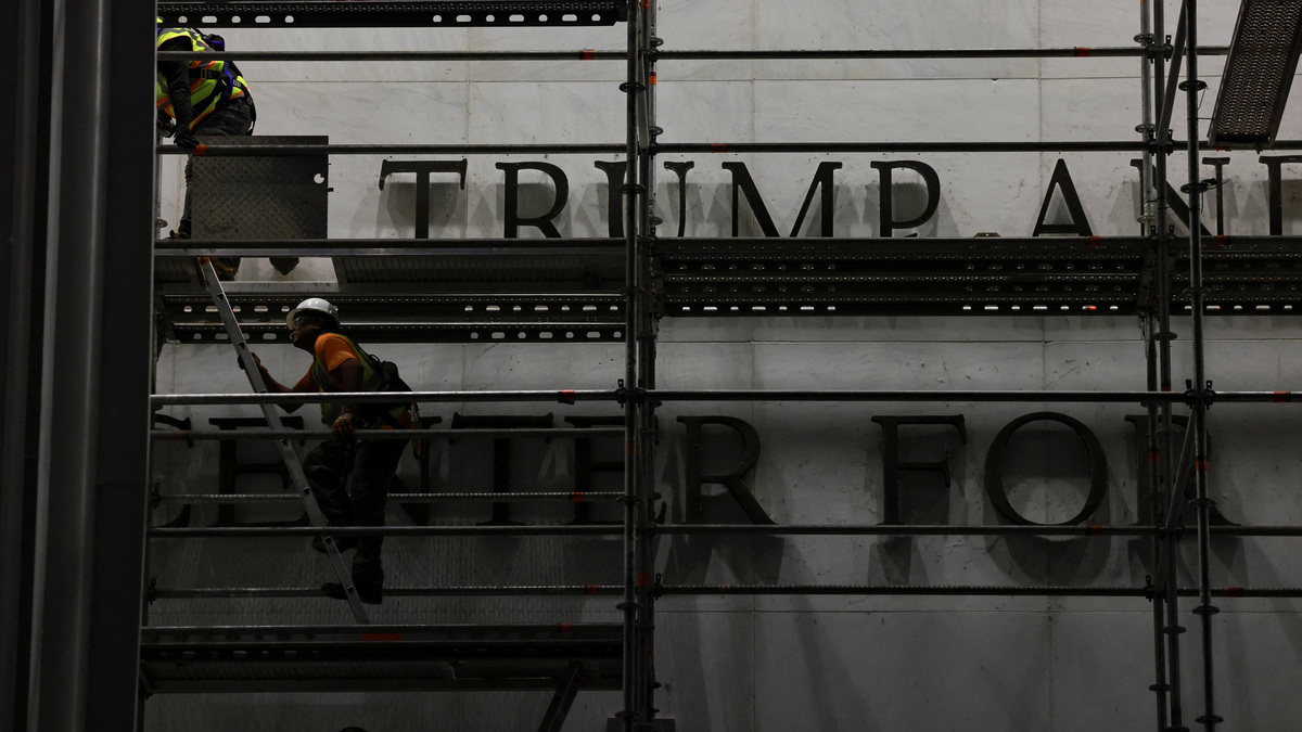 Workers prepare scaffolding ahead of removing lettering from the facade of the John F. Kennedy Memorial Center for the Performing Arts on Saturday in Washington, D.C., following a federal judge’s order to remove President Donald Trump's name from the institution.
