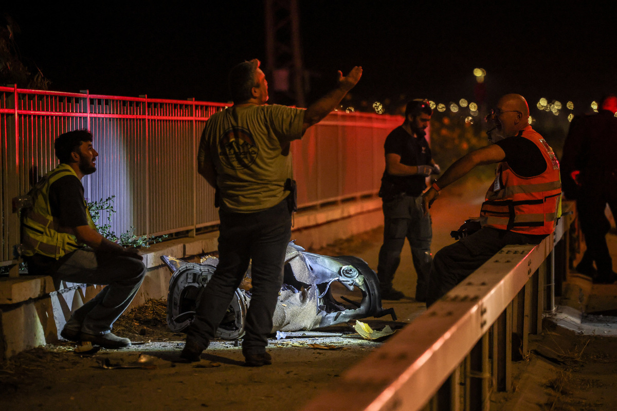Israeli security and rescue personnel work next to a part of a projectile following a missile attack from Iran towards Israel in northern Israel, June 8, 2026. REUTERS/Shir Torem
