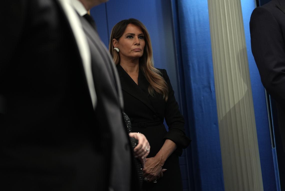 First lady Melania Trump looks on as President Donald Trump briefs reporters at the White House after shots were fired during the White House Correspondents' Association dinner at the Washington Hilton in Washington on Saturday, April 25, 2026. Trump was rushed from the stage but was unharmed. (Salwan Georges/The New York Times)