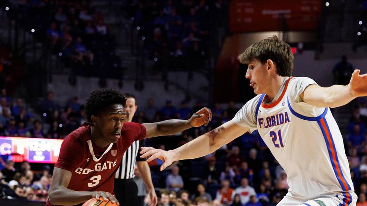  Dec 21, 2025; Gainesville, Florida, USA; Colgate Raiders guard Jalen Cox (3) drives to the basket while Florida Gators forward Alex Condon (21) defends during the first half at Exactech Arena at the Stephen C. O'Connell Center. Mandatory Credit: Matt Pendleton-Imagn Images | Matt Pendleton-Imagn Images 