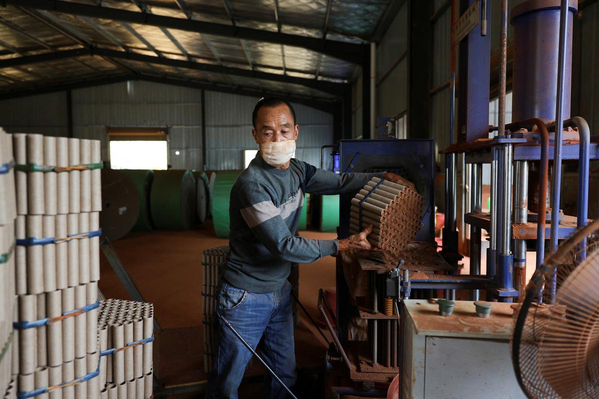 An employee works with a machine to assemble firework products at Chili Fireworks factory in Liling, Hunan province, China, April 9, 2026.  REUTERS/Go Nakamura